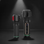 Two black massage devices on a dark background