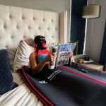 RECON Lumi Wrap with RECON Recovery Concierge logo, worn with the Lumi Mask in a bedroom setting